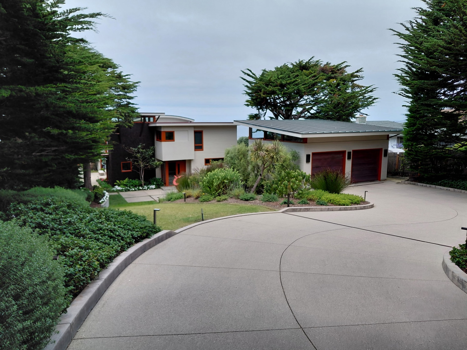 Full residential exterior with cleaned siding, driveway and landscaping in Monterey County